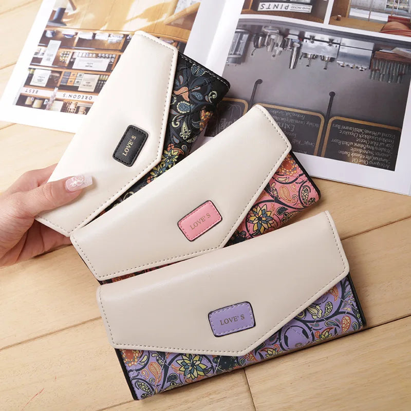 Beige wallets with floral patterns and 'LOVE S' branding