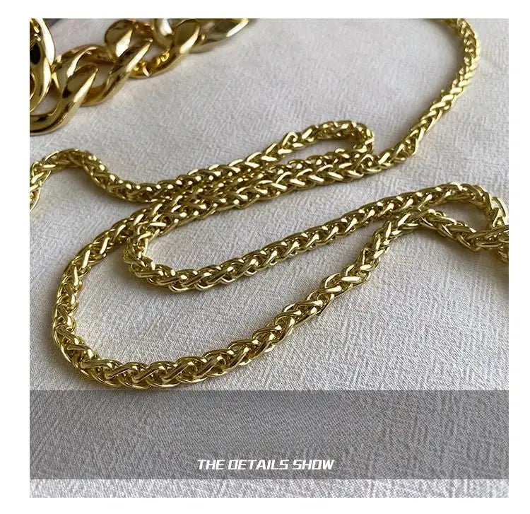Gold chain on a textured white surface