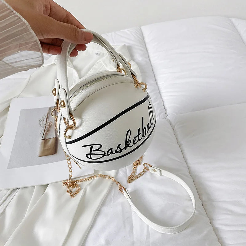 White handbag shaped like a basketball with 'Basketball' text on a white surface