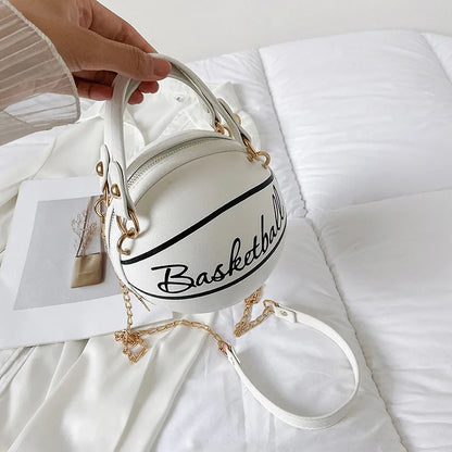 White handbag shaped like a basketball with 'Basketball' text on a white surface