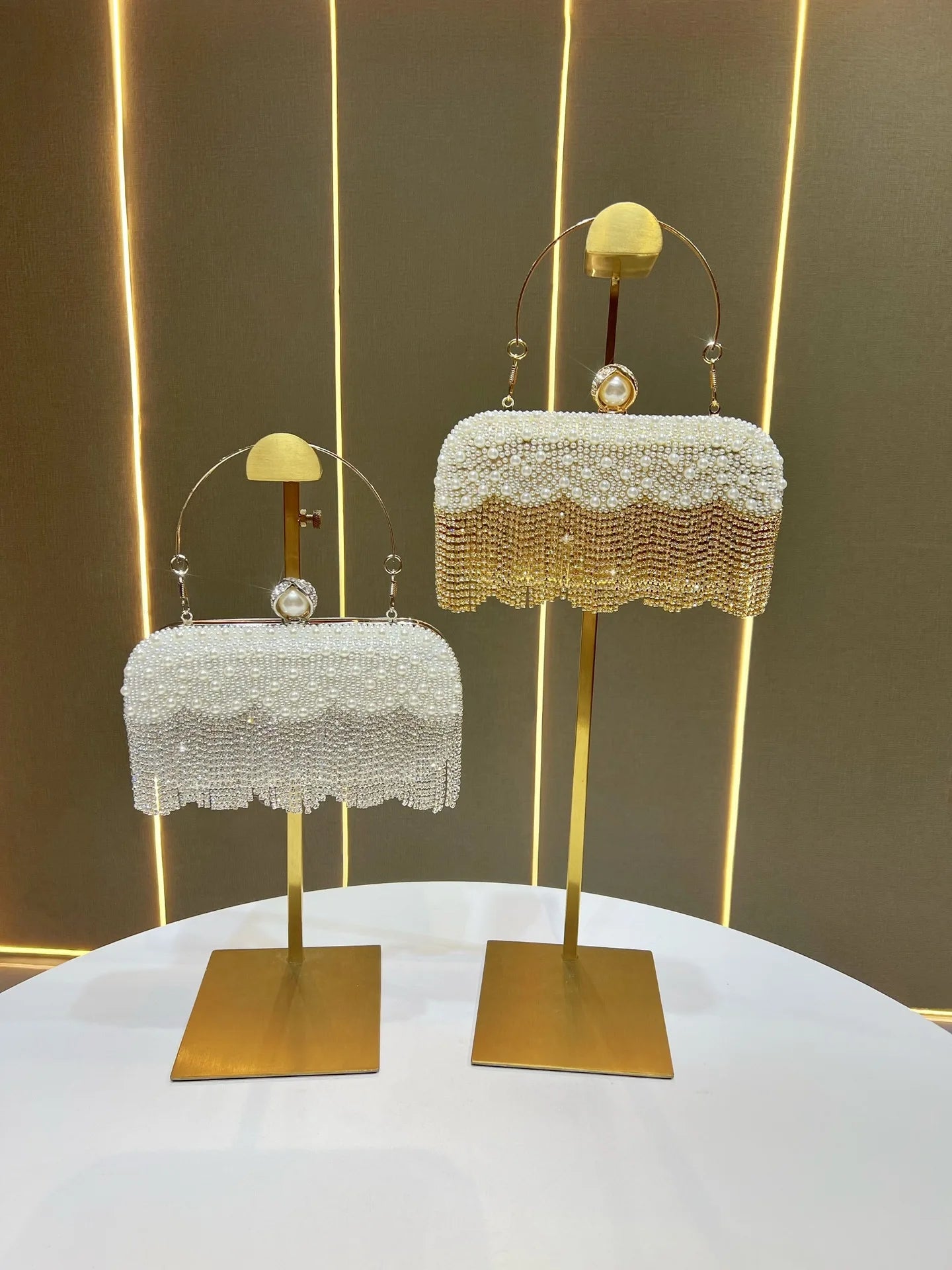 Two beaded Carauana Pearl Clutch Purse golden and silver on stand