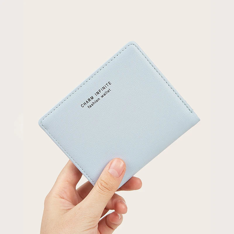 Light blue wallet held by a hand