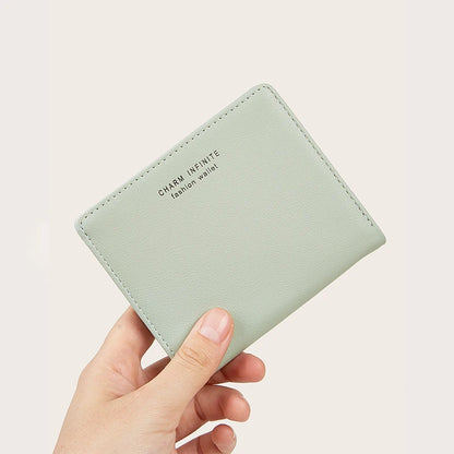 Light green wallet held by a hand